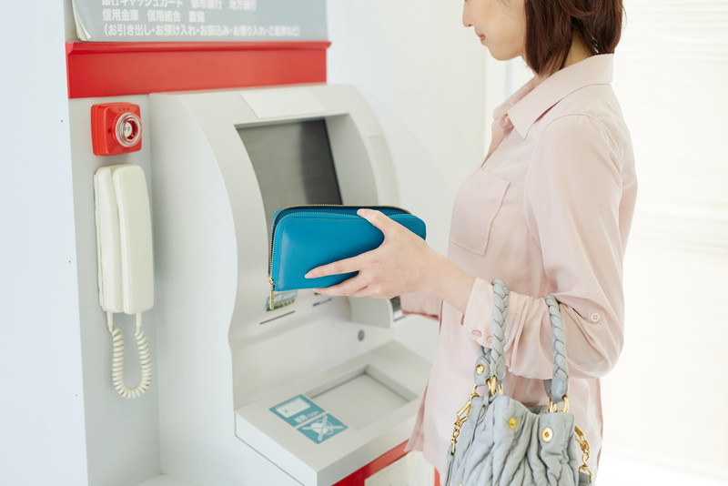 銀行ATMを操作する女性